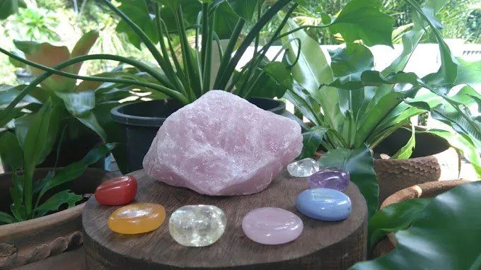 Rose quartz and polished crystals laid out for a session